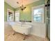 Bright bathroom featuring a clawfoot tub, beadboard paneling, and a chandelier at 8710 Mount Rushmore Dr, Johns Creek, GA 30022