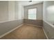 Neutral-toned bedroom featuring a clean carpet and natural light from the window at 8710 Mount Rushmore Dr, Johns Creek, GA 30022