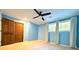 Spacious blue bedroom features a ceiling fan, and ample natural light from the windows at 8710 Mount Rushmore Dr, Johns Creek, GA 30022