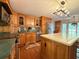 Well-equipped kitchen with wooden cabinetry, stainless steel appliances, and island seating at 8710 Mount Rushmore Dr, Johns Creek, GA 30022