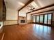 Spacious living room boasts a brick fireplace and exposed wood beams for a rustic charm at 8710 Mount Rushmore Dr, Johns Creek, GA 30022