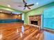 Bright living room with hardwood floors, a brick fireplace, and views to the backyard at 8710 Mount Rushmore Dr, Johns Creek, GA 30022