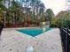 Community pool covered for the off-season, surrounded by trees, offering a peaceful recreation area at 8710 Mount Rushmore Dr, Johns Creek, GA 30022