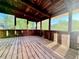 Enclosed porch featuring wood floors and screened windows offering a relaxing outdoor space at 8710 Mount Rushmore Dr, Johns Creek, GA 30022