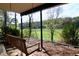Enjoy this porch with a wooden swing and beautiful scenery of the trees at 8710 Mount Rushmore Dr, Johns Creek, GA 30022