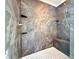 Modern shower with gray tile surround, a bench seat, and mosaic tile floor at 8710 Mount Rushmore Dr, Johns Creek, GA 30022