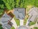 Aerial view showcases home's roof, driveway, landscaping, and proximity to neighboring houses in a residential area at 931 Hidden Falls Se Ln, Smyrna, GA 30082