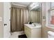 Bathroom with vanity and shower with decorative curtain at 931 Hidden Falls Se Ln, Smyrna, GA 30082