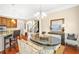 Bright breakfast nook featuring a modern chandelier, barstool seating, and backyard views at 931 Hidden Falls Se Ln, Smyrna, GA 30082