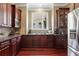 Gourmet kitchen featuring granite countertops, stainless steel appliances, wood cabinets, and a window over the sink at 931 Hidden Falls Se Ln, Smyrna, GA 30082