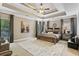 Spacious main bedroom with tray ceiling, fan, decorative rug, and elegant furnishings at 931 Hidden Falls Se Ln, Smyrna, GA 30082