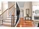 Elegant staircase with hardwood steps and railing, leading to a light-filled foyer and living room at 931 Hidden Falls Se Ln, Smyrna, GA 30082
