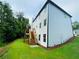 Spacious backyard featuring a grassy area and a stairway to the upper deck at 1540 Ox Bridge Ct, Lawrenceville, GA 30043