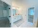 Bright bathroom features a double sink vanity, granite countertops, and a large mirror with modern lighting at 1540 Ox Bridge Ct, Lawrenceville, GA 30043