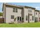 Spacious back yard features outdoor seating and mature trees in the distance at 3126 Cove View Ct, Dacula, GA 30019