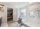 This is a bathroom with a glass shower, marble tile, and a small bench at 3126 Cove View Ct, Dacula, GA 30019
