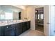 This is a bathroom with a double sink, a walk-in shower, and a glimpse into the main bedroom at 3126 Cove View Ct, Dacula, GA 30019