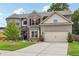 Two-story home with brick and siding, mature landscaping, driveway, and attached two-car garage at 3126 Cove View Ct, Dacula, GA 30019