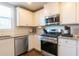 Spacious kitchen featuring stainless steel appliances, granite countertops, and sleek white cabinets at 3126 Cove View Ct, Dacula, GA 30019