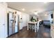 Modern kitchen with stainless steel appliances, white cabinetry, dining area and living room view at 3126 Cove View Ct, Dacula, GA 30019