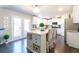 Bright eat-in kitchen featuring an island with wine rack, bar stool seating and access to the backyard at 3126 Cove View Ct, Dacula, GA 30019