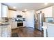 The renovated kitchen features stainless steel appliances, granite countertops, and modern cabinetry at 3126 Cove View Ct, Dacula, GA 30019