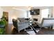 Open concept living room with hardwood floors, stylish seating, fireplace, and natural light at 3126 Cove View Ct, Dacula, GA 30019