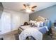Comfortable carpeted main bedroom features a ceiling fan, and an ornamental headboard at 3126 Cove View Ct, Dacula, GA 30019