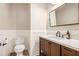 Half bathroom featuring a wood vanity, white counter, and decorative wainscoting at 300 Windsor Chase Trl, Johns Creek, GA 30097