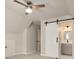 Bedroom with barn door entry to the ensuite bathroom at 300 Windsor Chase Trl, Johns Creek, GA 30097
