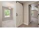 This bedroom features stylish barn doors, neutral carpeting, and a bright window with natural light at 300 Windsor Chase Trl, Johns Creek, GA 30097
