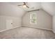 Carpeted bedroom with sloped ceilings and one window at 300 Windsor Chase Trl, Johns Creek, GA 30097