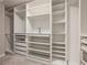 This large walk-in closet features plenty of shelving for storage and organization at 300 Windsor Chase Trl, Johns Creek, GA 30097