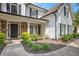 Inviting front entrance with stone accents, a covered porch, and manicured landscaping leading to the front door at 300 Windsor Chase Trl, Johns Creek, GA 30097