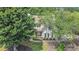 Beautiful two-story home with lush green trees, well-maintained landscaping, and inviting curb appeal at 300 Windsor Chase Trl, Johns Creek, GA 30097