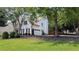 Well-maintained home with a visible two-car garage, set on a neatly kept lawn with mature trees at 300 Windsor Chase Trl, Johns Creek, GA 30097