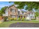Charming two-story home featuring stone accents, white siding, and a well-manicured front yard at 300 Windsor Chase Trl, Johns Creek, GA 30097