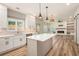 Bright, open kitchen featuring a center island with modern lighting and stainless steel appliances at 300 Windsor Chase Trl, Johns Creek, GA 30097