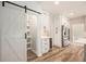 Open kitchen featuring a barn door pantry, stainless steel appliances, and lots of cabinet space at 300 Windsor Chase Trl, Johns Creek, GA 30097
