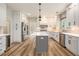 Modern kitchen featuring white cabinets, stainless steel appliances, a center island, and wood-look flooring at 300 Windsor Chase Trl, Johns Creek, GA 30097