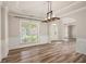 Spacious living room with hardwood floors, abundant natural light, and elegant trim details at 300 Windsor Chase Trl, Johns Creek, GA 30097