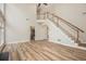 Living room with hardwood floors, staircase, and an open layout at 300 Windsor Chase Trl, Johns Creek, GA 30097