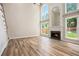 Bright living room featuring a fireplace, hardwood floors, and lots of natural light at 300 Windsor Chase Trl, Johns Creek, GA 30097