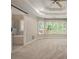 The main bedroom features large windows, neutral carpet, and an elegant tray ceiling with a ceiling fan at 300 Windsor Chase Trl, Johns Creek, GA 30097