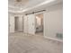 This main bedroom boasts great natural light, neutral carpet, and barn door access to a bathroom with double vanity at 300 Windsor Chase Trl, Johns Creek, GA 30097