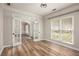 Bright office with wood-look flooring, white trim, and a view into the adjacent room through glass French doors at 300 Windsor Chase Trl, Johns Creek, GA 30097