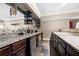 Basement wet bar features granite counters, dark cabinetry and small fridge at 1122 Parkview Pl, Smyrna, GA 30080