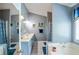 Primary bathroom features double sinks, soaking tub and patterned shower curtain at 1055 Kibbe Cir, Lawrenceville, GA 30044