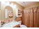 Cozy bathroom featuring a glass sink, decorative tile, and shower with framed mirror at 1055 Kibbe Cir, Lawrenceville, GA 30044