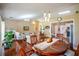 Dining room that flows to living areas, showcasing an open concept, hardwood floors, and natural light at 1055 Kibbe Cir, Lawrenceville, GA 30044